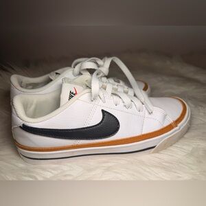Nike White Sneakers with Orange Trim and Black Swoosh